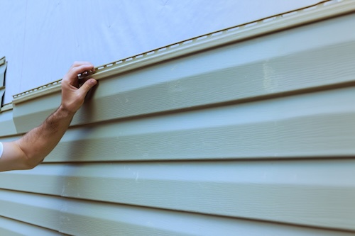 Contractor Installing New Vinyl Siding on Exterior of Home | Rolox Home Services LLC