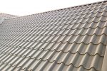 Close up of new house roof structure covered with metal tile sheets.